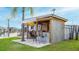 Outdoor tiki bar featuring a surfboard awning, bar seating, and charming nautical decor at 108 W Saint Johns Way # 210, Apollo Beach, FL 33572