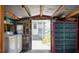 Functional utility room with washer, dryer, storage, and access to the outdoors at 108 W Saint Johns Way # 210, Apollo Beach, FL 33572