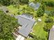 Aerial view highlighting the screened pool and expansive backyard, surrounded by lush greenery and a peaceful pond at 1271 Candlelight Blvd, Brooksville, FL 34601