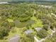 Breathtaking aerial view showcasing lush greenery, a large pond, and well-spaced homes in a peaceful, suburban setting at 1271 Candlelight Blvd, Brooksville, FL 34601