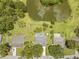 Captivating aerial view highlighting a charming home with a pool, a large pond, and expansive yards in a desirable neighborhood at 1271 Candlelight Blvd, Brooksville, FL 34601