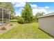 Large backyard with a storage shed, screened-in porch and a tranquil pond view at 1271 Candlelight Blvd, Brooksville, FL 34601
