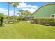 Picturesque backyard with a screened-in porch, lush lawn, and waterfront view at 1271 Candlelight Blvd, Brooksville, FL 34601
