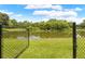 Beautiful backyard view showcasing a serene pond surrounded by lush greenery at 1271 Candlelight Blvd, Brooksville, FL 34601