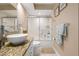 Bathroom featuring glass enclosed shower-over-tub, granite vanity, large mirror, and decorative towels at 1271 Candlelight Blvd, Brooksville, FL 34601