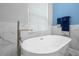 Elegant bathroom featuring a soaking tub, a sleek faucet and marble wall at 1271 Candlelight Blvd, Brooksville, FL 34601