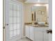 Bright bathroom with a white vessel sink, granite countertop, and white cabinets, next to the entry door at 1271 Candlelight Blvd, Brooksville, FL 34601