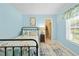 Nautical themed bedroom with light blue walls, window, closet, ceiling fan, and wood-look floors at 1271 Candlelight Blvd, Brooksville, FL 34601