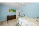 Nautical themed bedroom with light blue walls, window, closet, ceiling fan, wood-look floors, and TV at 1271 Candlelight Blvd, Brooksville, FL 34601