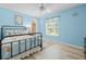 Nautical themed bedroom with light blue walls, window, closet, ceiling fan, and wood-look floors at 1271 Candlelight Blvd, Brooksville, FL 34601