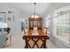 Elegant dining room featuring a chandelier, large windows, and a wooden dining table at 1271 Candlelight Blvd, Brooksville, FL 34601