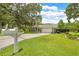 Inviting green home with a well-manicured lawn and decorative mailbox at 1271 Candlelight Blvd, Brooksville, FL 34601
