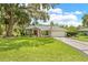 Exterior view of a green home showcasing its well-maintained lawn and curb appeal at 1271 Candlelight Blvd, Brooksville, FL 34601