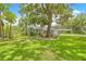 Charming home with a large, well-maintained front yard and mature trees providing ample shade at 1271 Candlelight Blvd, Brooksville, FL 34601