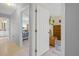 Hallway with view into bedroom, featuring wood floors, dresser, TV, and another view into en-suite bathroom at 1271 Candlelight Blvd, Brooksville, FL 34601