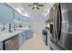 Kitchen with stainless steel appliances, white countertops, and blue cabinets at 1271 Candlelight Blvd, Brooksville, FL 34601