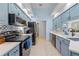 Updated kitchen with blue cabinets, modern appliances, and white countertops at 1271 Candlelight Blvd, Brooksville, FL 34601