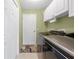 Laundry room with white cabinets, washer, dryer, and white door at 1271 Candlelight Blvd, Brooksville, FL 34601