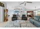 Open-concept living room features vaulted ceilings, tile flooring, and access to dining and kitchen at 1271 Candlelight Blvd, Brooksville, FL 34601