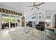 Open-concept living room with a ceiling fan and natural light at 1271 Candlelight Blvd, Brooksville, FL 34601