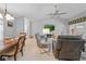 Cozy living room with vaulted ceiling, fireplace, and dining area with views of the backyard at 1271 Candlelight Blvd, Brooksville, FL 34601