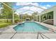Sparkling private pool with a screened enclosure, patio, and lush greenery at 1271 Candlelight Blvd, Brooksville, FL 34601