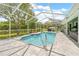 Private pool with screened enclosure and serene views of the surrounding landscape at 1271 Candlelight Blvd, Brooksville, FL 34601