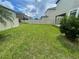 Large, well-maintained backyard features a lush lawn and privacy fence at 1596 Ludington Ave, Wesley Chapel, FL 33543