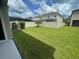 A spacious backyard with lush green grass and a white picket fence at 1596 Ludington Ave, Wesley Chapel, FL 33543