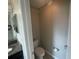 Powder room featuring gray walls and granite counters at 1596 Ludington Ave, Wesley Chapel, FL 33543