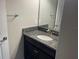 Well-lit vanity with granite countertop and modern faucet in a minimalist bathroom at 1596 Ludington Ave, Wesley Chapel, FL 33543