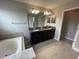 Bathroom with double sink vanity and large bathtub at 1596 Ludington Ave, Wesley Chapel, FL 33543