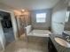 Bathroom featuring a separate shower and large soaking tub at 1596 Ludington Ave, Wesley Chapel, FL 33543