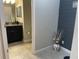 Cozy bathroom with vanity, wainscoting detail, and warm neutral tones at 1596 Ludington Ave, Wesley Chapel, FL 33543