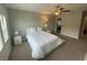 Bedroom with a large bed, soft lighting, and a doorway to the bathroom at 1596 Ludington Ave, Wesley Chapel, FL 33543