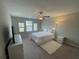 Bright bedroom featuring a large bed, a TV, and lots of natural light at 1596 Ludington Ave, Wesley Chapel, FL 33543