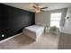Comfortable bedroom with a black accent wall and ceiling fan at 1596 Ludington Ave, Wesley Chapel, FL 33543