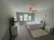 Bright bedroom with a large bed, a TV, and lots of natural light at 1596 Ludington Ave, Wesley Chapel, FL 33543