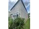 Two-story home showing landscaping, stucco and window trim under partially cloudy skies at 1596 Ludington Ave, Wesley Chapel, FL 33543