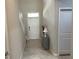 Bright foyer with tiled flooring, a console table, and a welcoming front door at 1596 Ludington Ave, Wesley Chapel, FL 33543