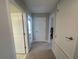 Hallway features access to multiple rooms and ample natural light at 1596 Ludington Ave, Wesley Chapel, FL 33543