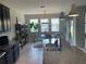 Bright kitchen featuring dark cabinetry, granite counters, and a view of the dining area at 1596 Ludington Ave, Wesley Chapel, FL 33543