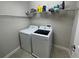 Well-lit laundry room equipped with modern washer and dryer at 1596 Ludington Ave, Wesley Chapel, FL 33543