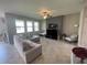 Comfortable living room featuring neutral tones, tile floors, and a modern entertainment center at 1596 Ludington Ave, Wesley Chapel, FL 33543