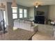 Open living room with a comfortable couch, TV, and plenty of natural light from the windows at 1596 Ludington Ave, Wesley Chapel, FL 33543