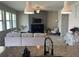 View from kitchen into the open living room and dining area at 1596 Ludington Ave, Wesley Chapel, FL 33543