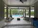 Resort-style pool area with covered seating and a beautiful pergola for shade at 1596 Ludington Ave, Wesley Chapel, FL 33543