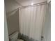 Shower features a white shower curtain and basic fixtures at 1596 Ludington Ave, Wesley Chapel, FL 33543