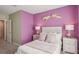 The bedroom is painted in a soft purple, accented by decorative elements that add personality and style at 17469 Spanish Oak Loop, Land O Lakes, FL 34638