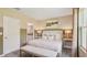 This primary bedroom features a neutral color scheme, an ensuite bathroom, and a comfortable seating bench at 17469 Spanish Oak Loop, Land O Lakes, FL 34638